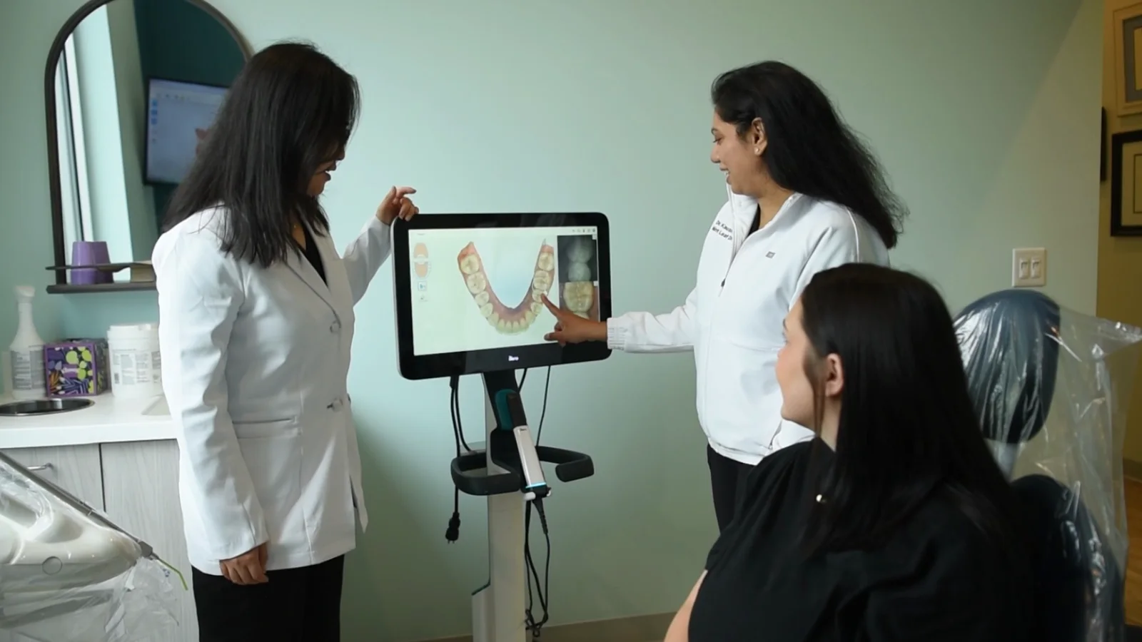 Dr. Gandhi reviewing a 3D digital smile scan with a patient at Mint Leaf Dentistry